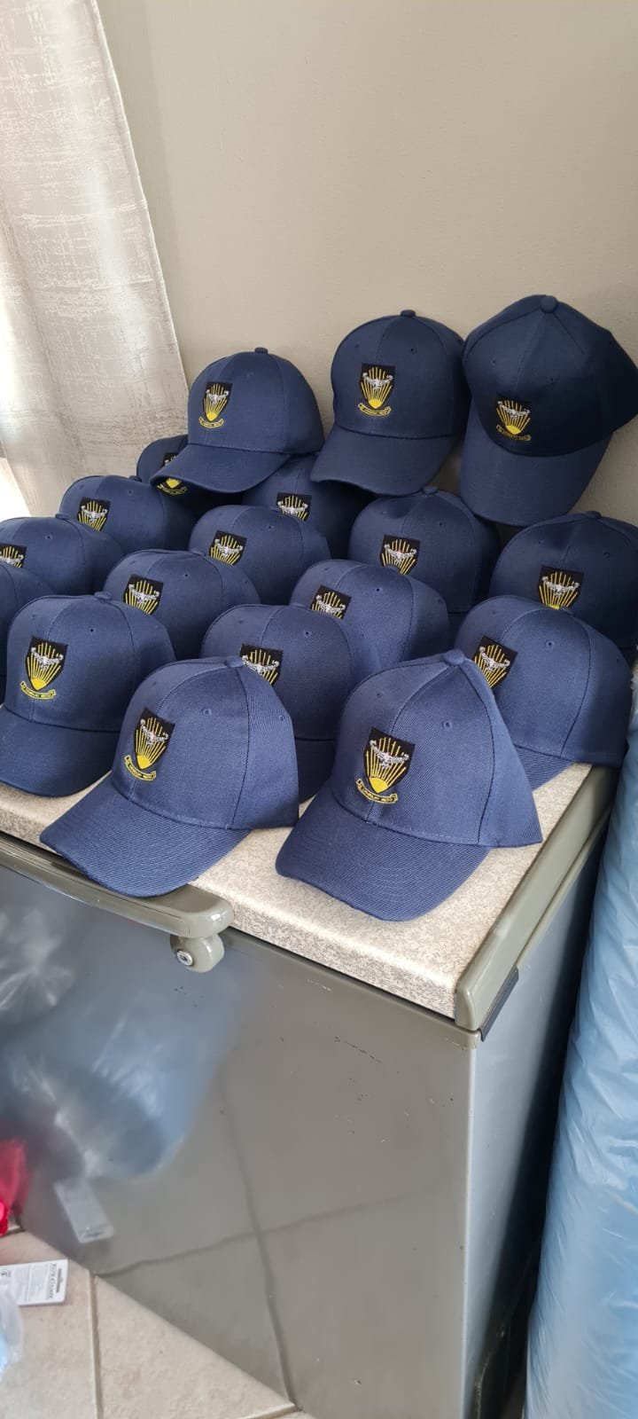 Batch of navy embroidered branded caps — M2 Embroidery