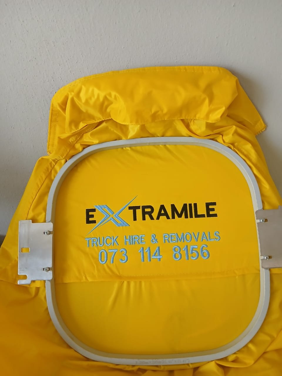 Extramile logo embroidered in hoop — M2 Embroidery