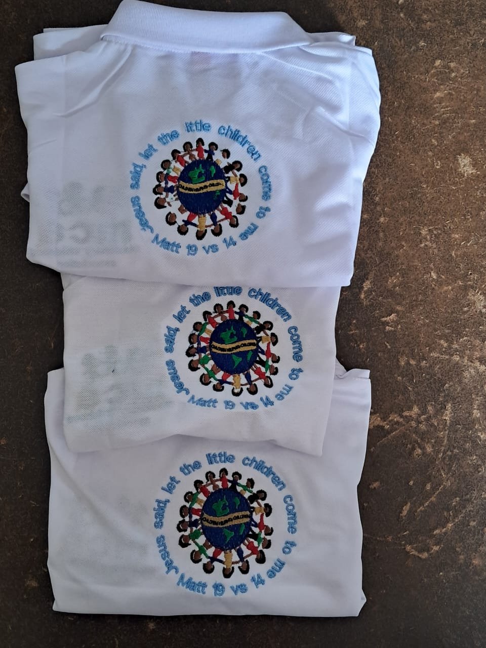 Children of Christ embroidered white polos — M2 Embroidery